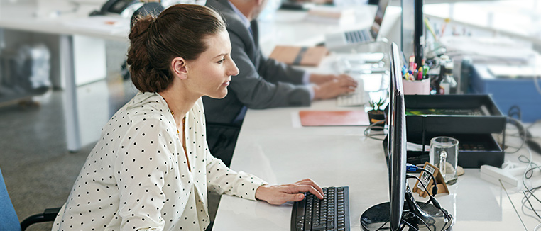 Businesswoman in office working on her computer